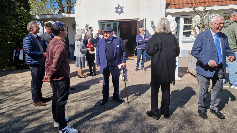Gerard Klein (midden) groet de aanwezigen. Hij kijkt naar zijn kleinzoon, die ook aanwezig was bij de herdenking.